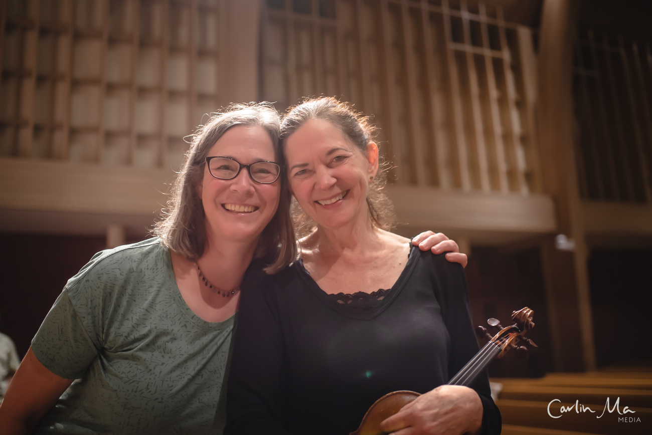 two musicians posing for a photo in rehearsal